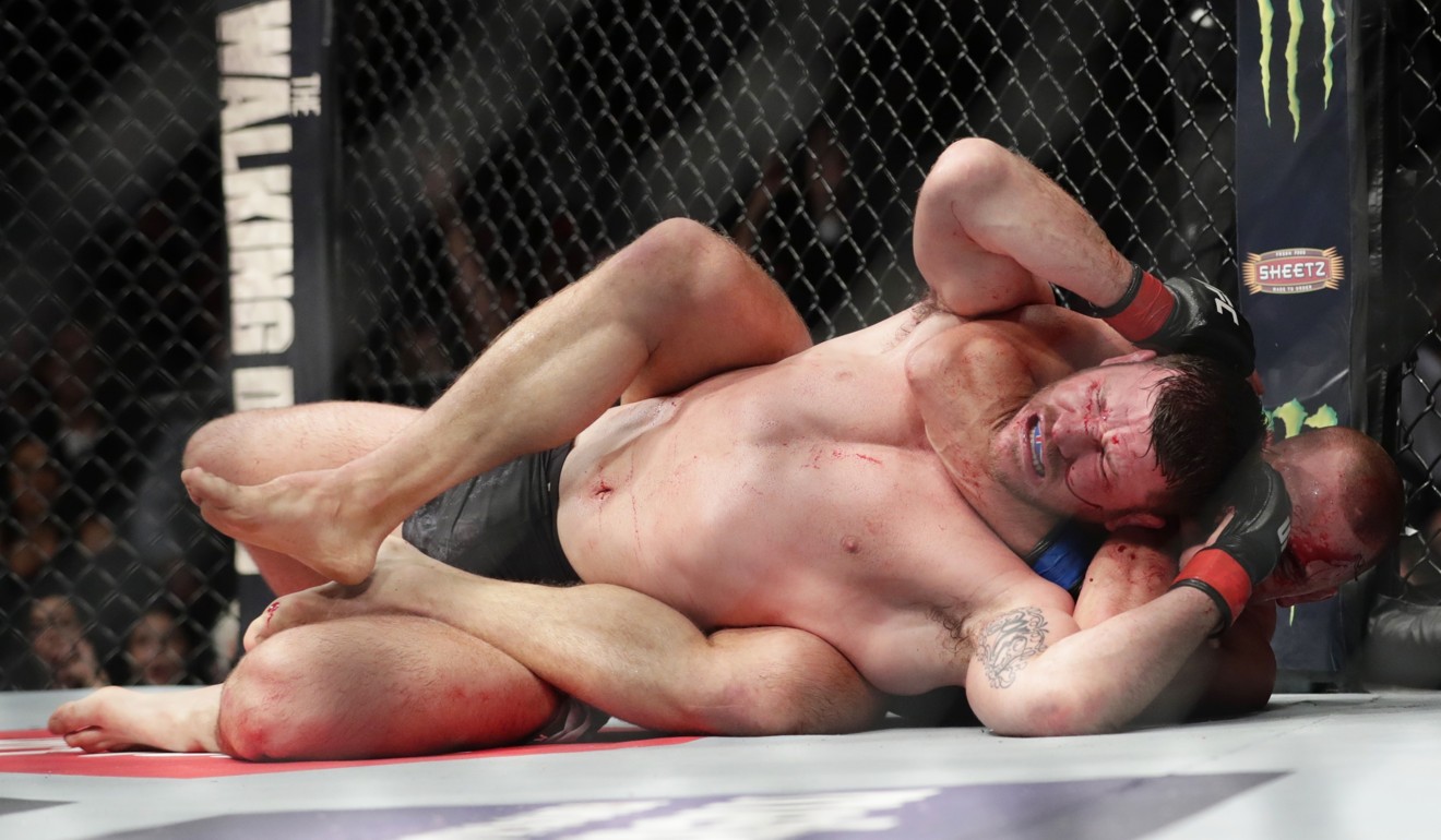 Georges St-Pierre chokes out Michael Bisping at UFC 217. Photo: AP