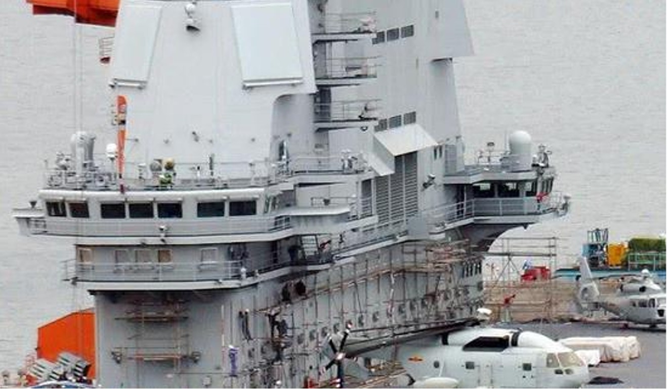 Scaffolding seen around the warship’s flight control tower suggests it is undergoing basic exterior work. Photo: Handout