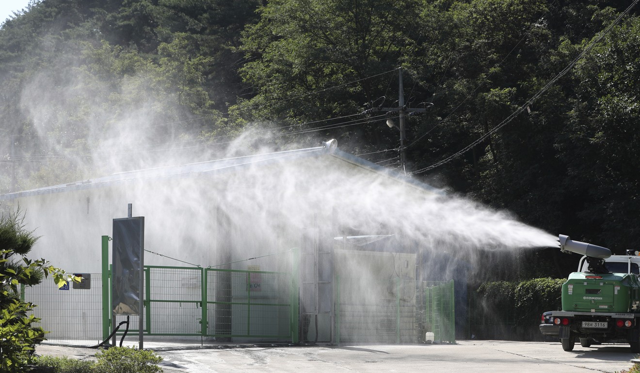 Disinfectant solution is sprayed as a precaution against African swine fever at a pig farm in Yanggu, South Korea. Photo: AP