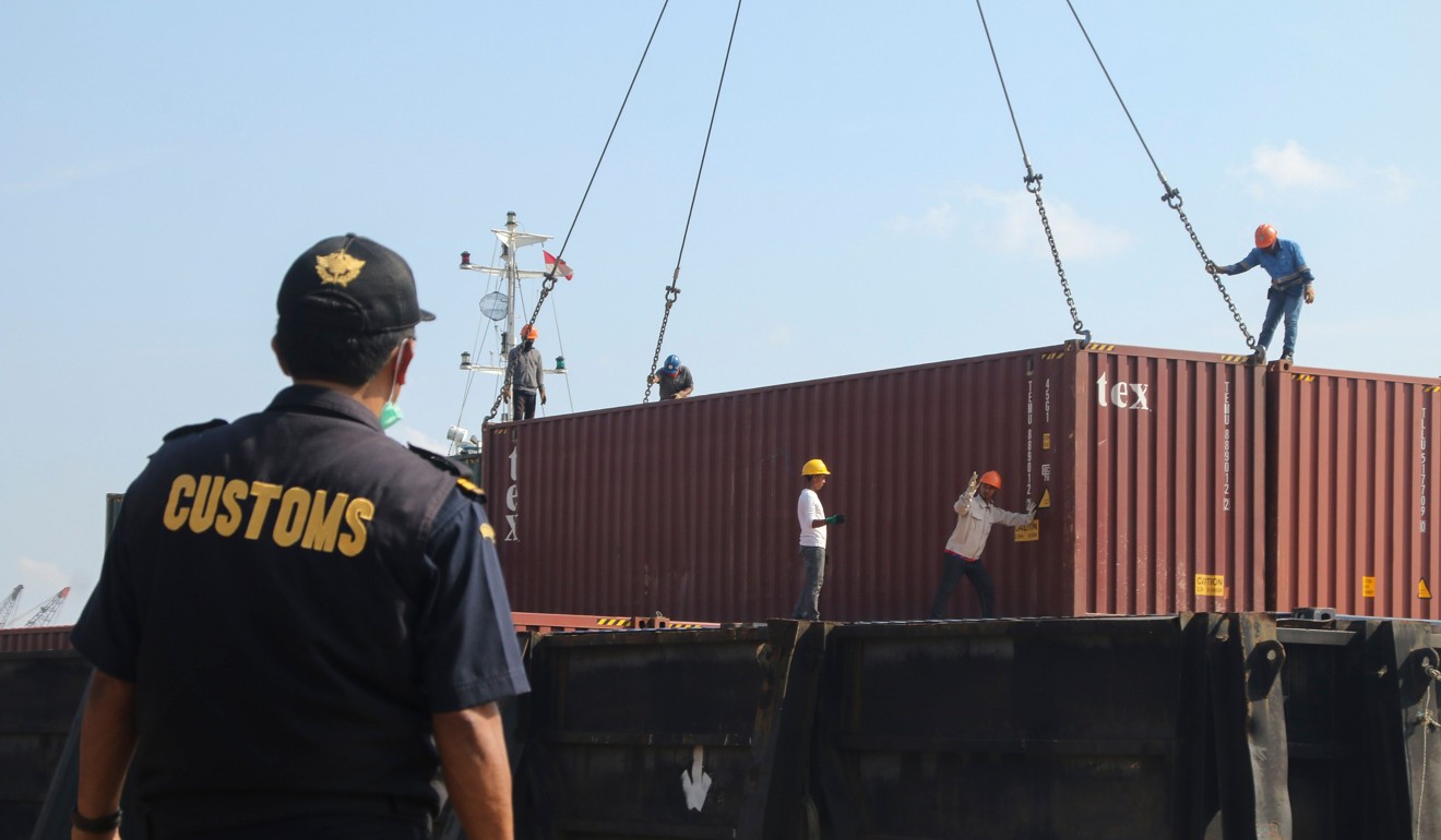 Indonesian custom officers prepare to return containers filled with hazardous rubbish to their countries of origin in July. Photo: AFP