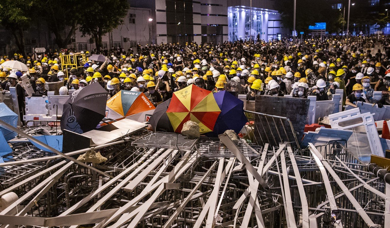 Demonstrators gather behind a barricade as they stand off against riot police during a protest in Hong Kong on July 1. “I support their right of expression, but I don’t support what they expressed,” one mainlander studying in the US said. Photo: Bloomberg
