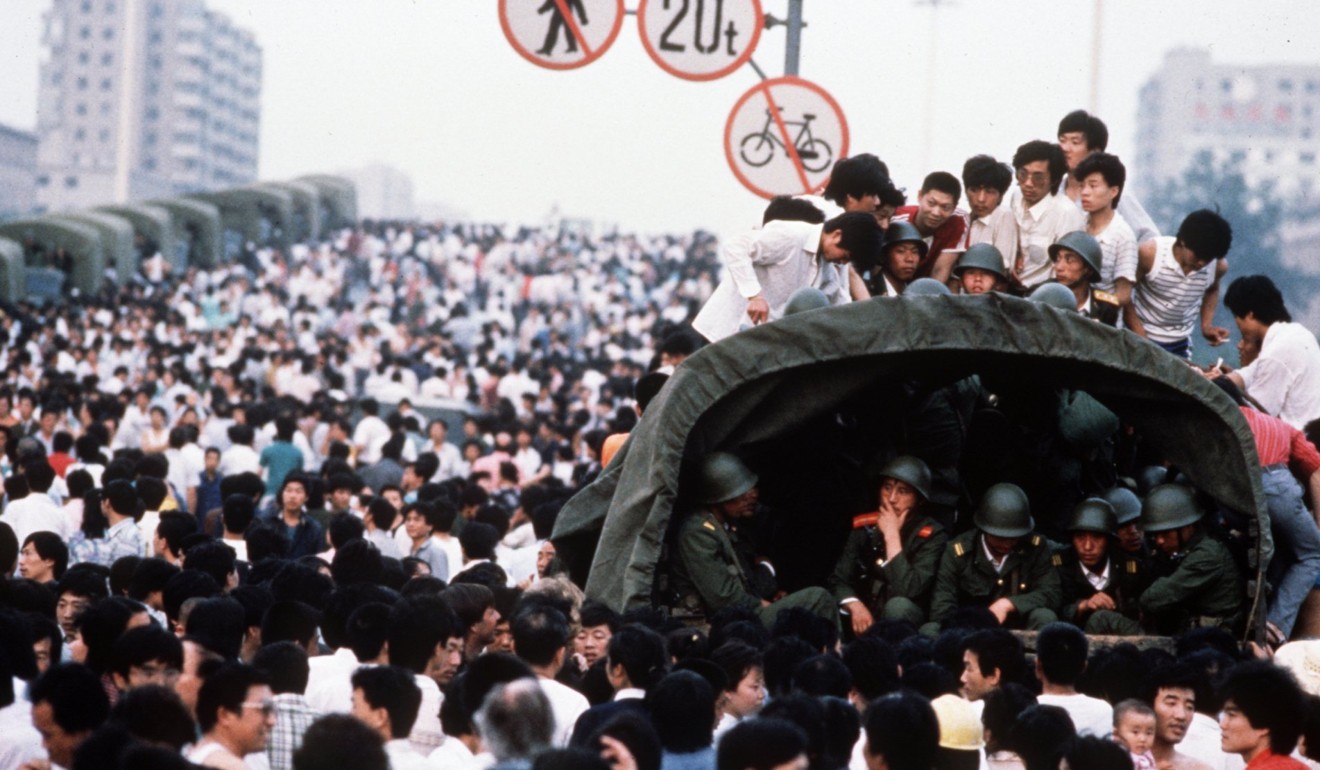 Students are among the Beijing crowds surrounding military trucks carrying soldiers on their way to Tiananmen Square, a day before the bloody crackdown on June 4. Photo: Sygma Agency
