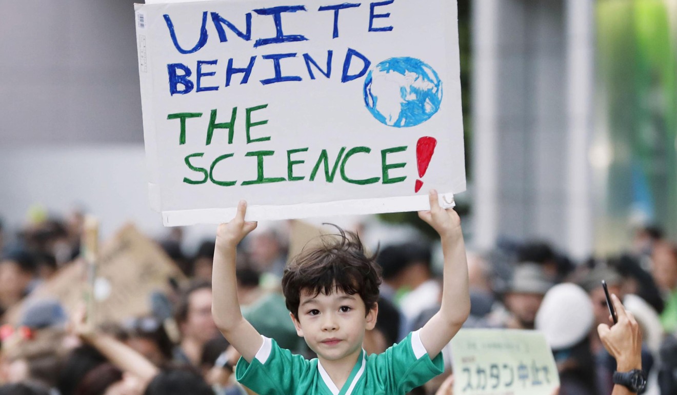 A boy is among people participating in a rally in Tokyo. Photo: Kyodo News via AP