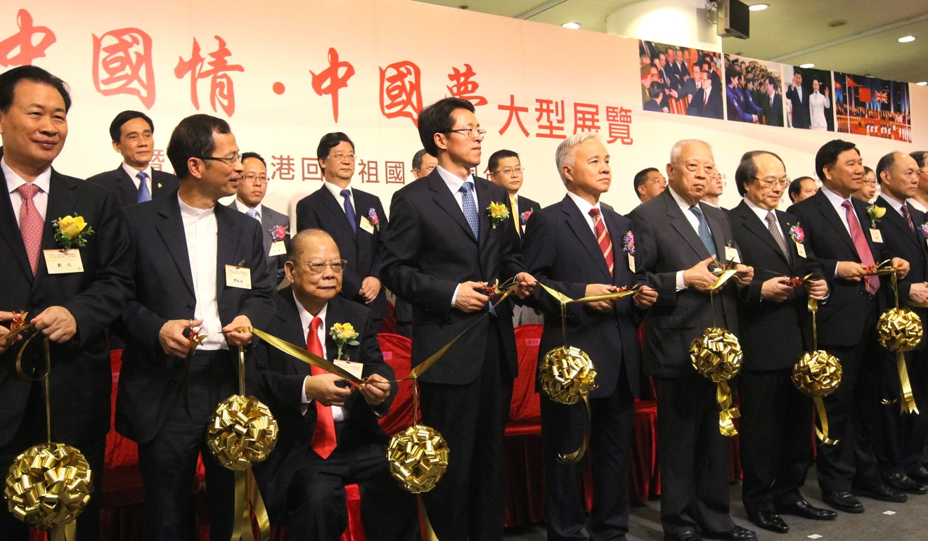 Guests including Tsang (seated) attend the opening ceremony of photo exhibition “Chinese Love China Dream” to celebrate the 16th anniversary of the handover in 2013. Photo: