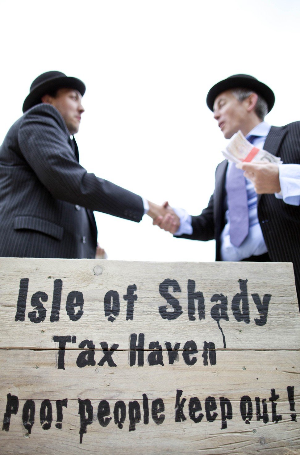 Protesters dressed up as shady businessmen calling for a crackdown on tax havens, in London in 2013. Photo: AFP