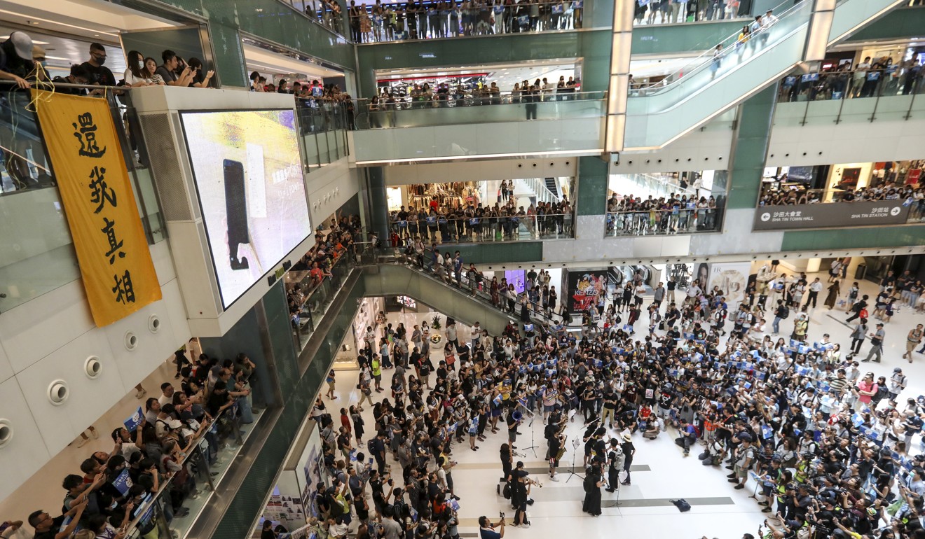 Protesters gather to sing ‘Glory to Hong Kong’ and other anthems of the anti-government movement at New Town Plaza in Sha Tin on Sunday afternoon. Photo: Nora Tam