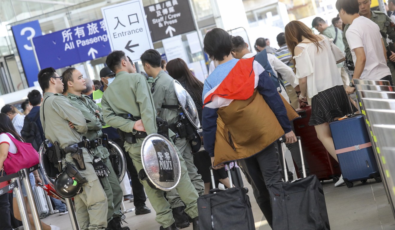 Riot police stationed at Hong Kong airport on Sunday amid the threat of organised disruption. Photo: K. Y. Cheng