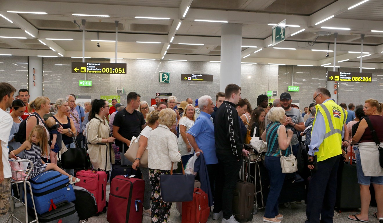 Passengers at Thomas Cook check-in points at Mallorca Airport after the world's oldest travel firm collapsed. Photo: Reuters