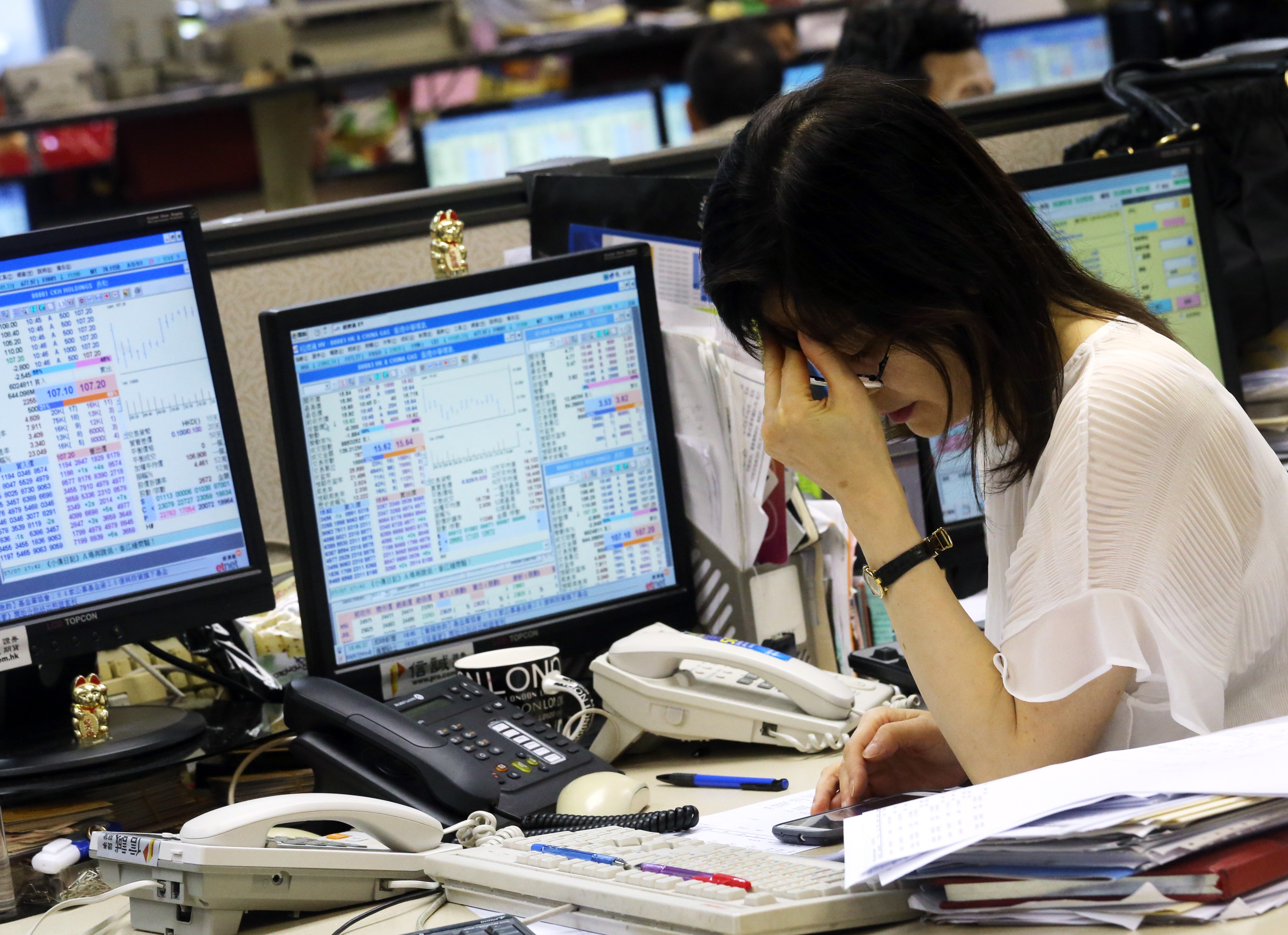 A stock broker looking at the stock market at World Wide House in Central on 8 July 2015. Photo: SCMP
