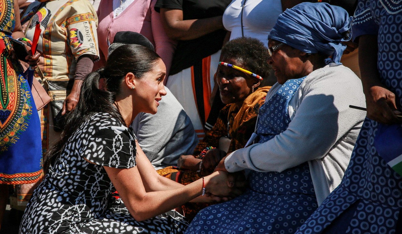 Meghan, Duchess of Sussex speaks with a woman during a visit to Justice Fesk, an NGO in the township of Nyanga, on Monday. Photo: AFP