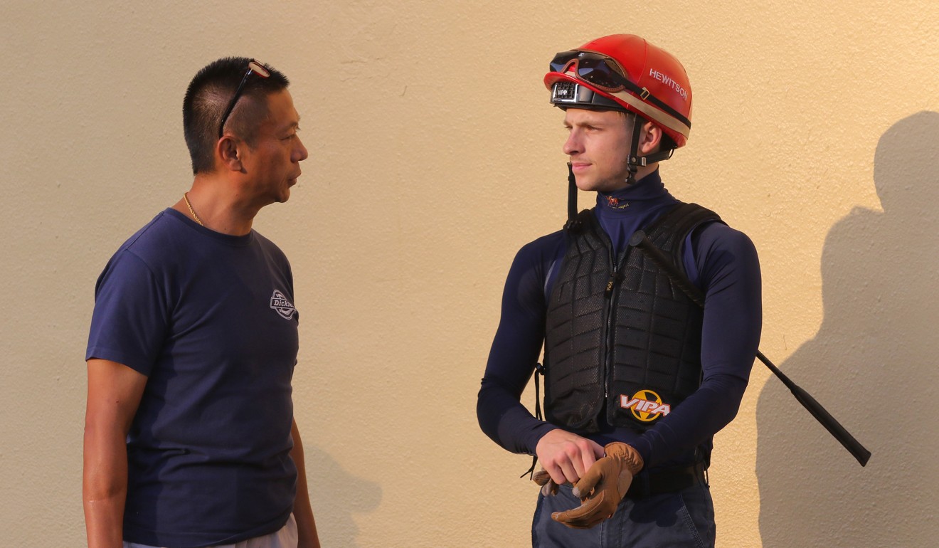 Jockey Lyle Hewitson and trainer Danny Shum chat during barrier trials at Happy Valley.