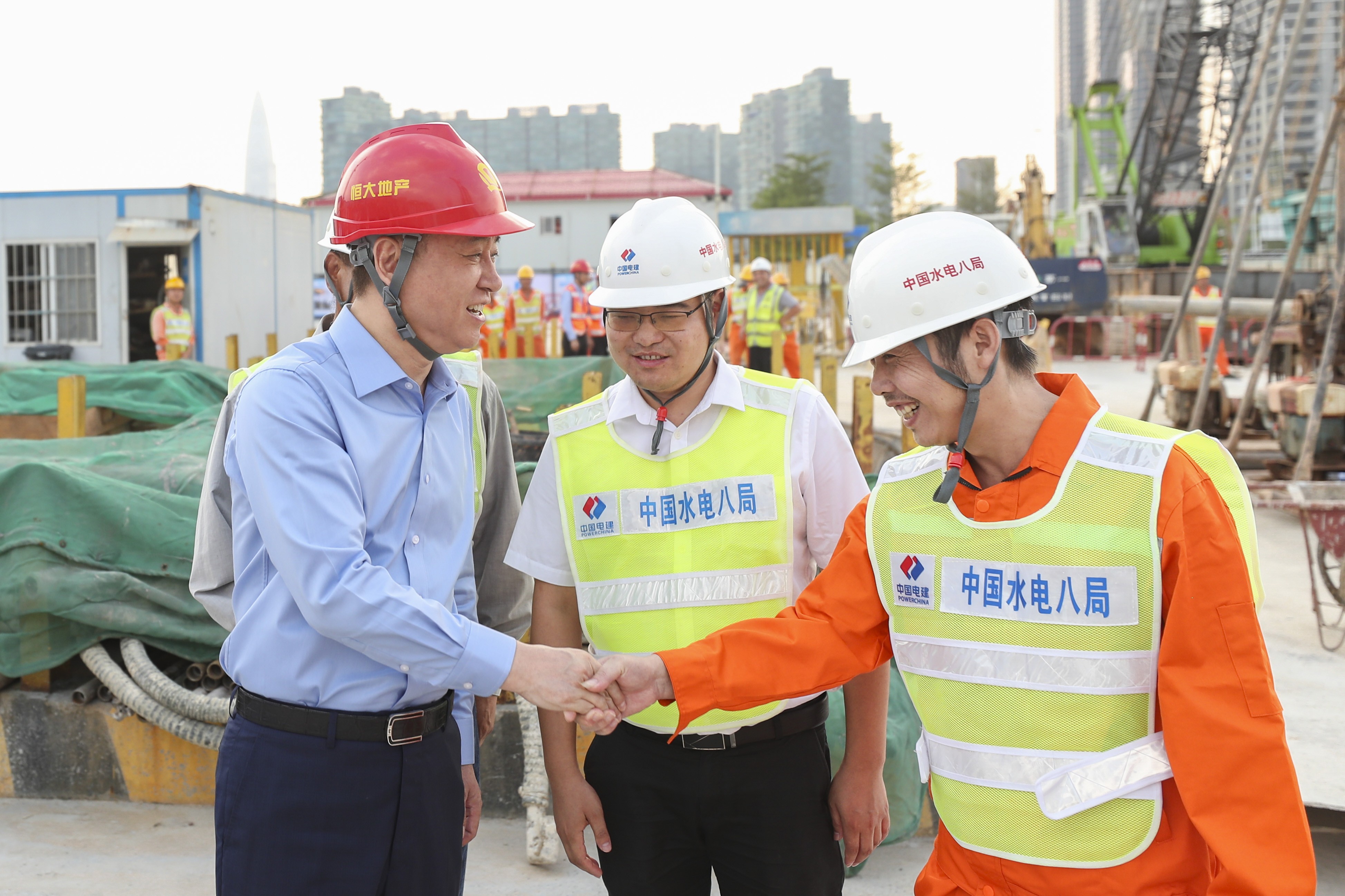 Xu Jiayin, left, the billionaire chairman and founder of China Evergrande, during his visit to the construction site of the company's new headquarters in Shenzhen’s Nanshan district. Photo: Handout