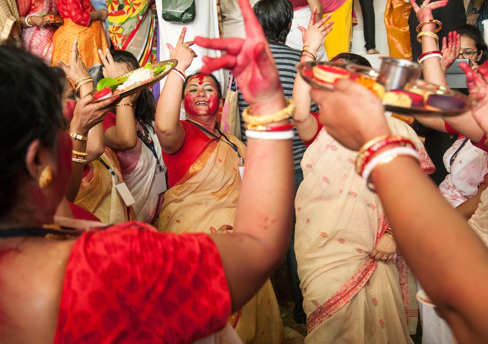 Married Bengali women dancing to a drum beat at the end of Durga Puja. Photo: Alamy