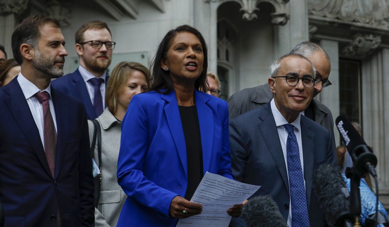 Gina Miller (in blue) and David Pannick (second right) outside the Supreme Court in London following their victory over the government of Boris Johnson. Photo: Bloomberg