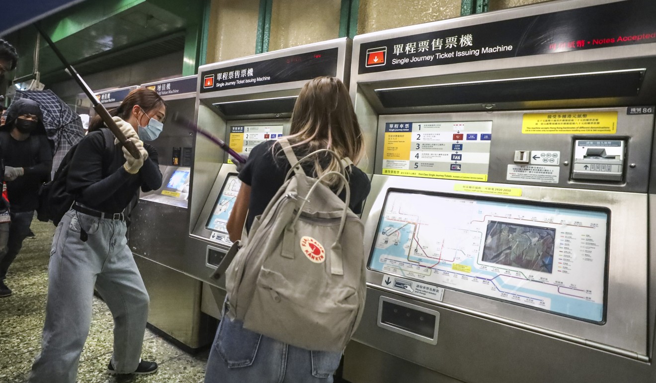 Protesters vandalise ticketing machines at Kwai Fong MTR station. Photo: Dickson Lee