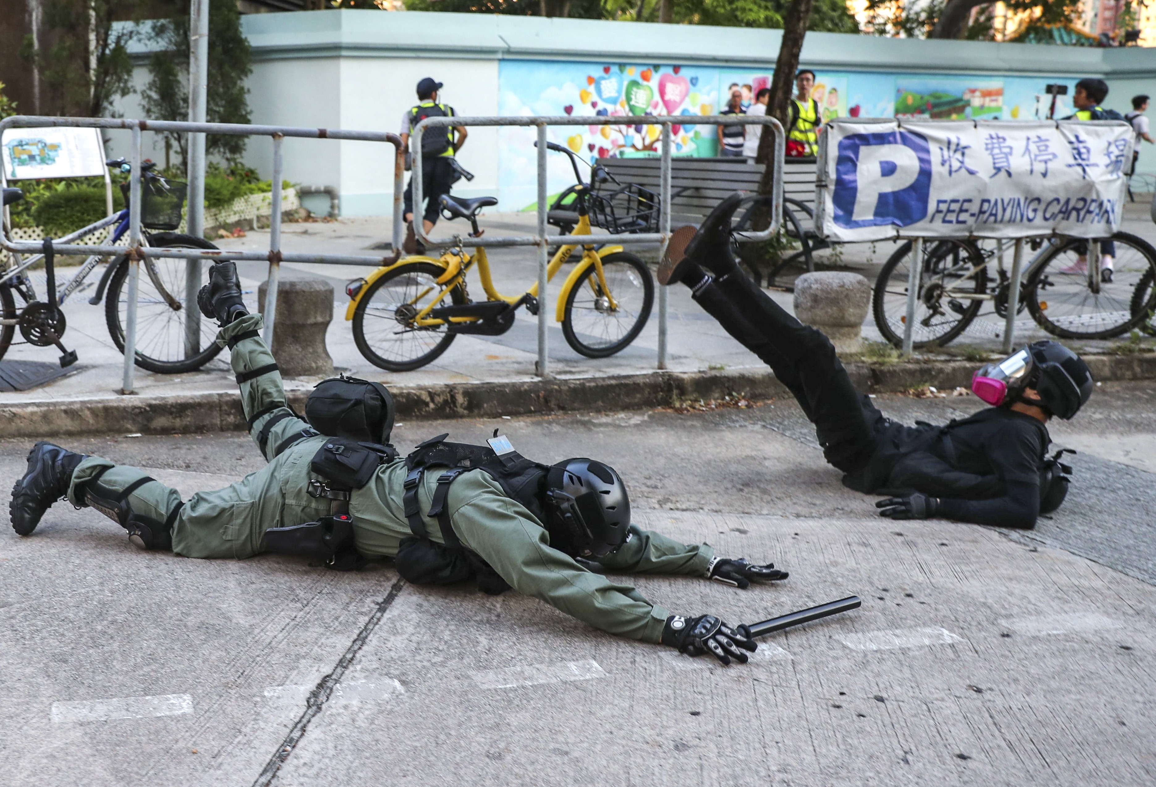 A riot police officer stumbles as he attempts to arrest an anti-government protester in Sha Tin, Hong Kong, on September 22. Protesters and police have a lot more in common than Beijing and the police. Photo: Sam Tsang