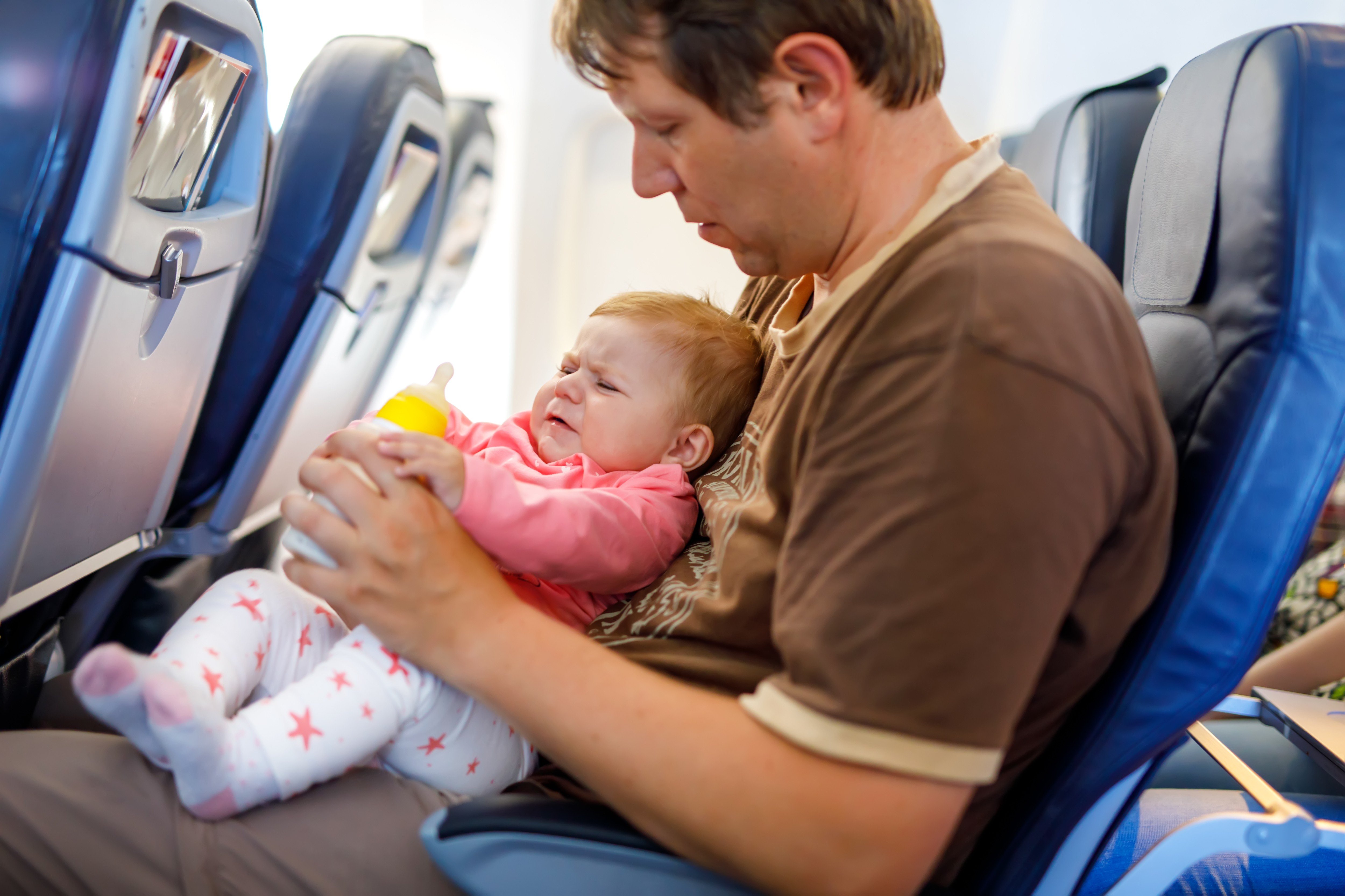 A father holds his daughter during a flight. Photo: Handout