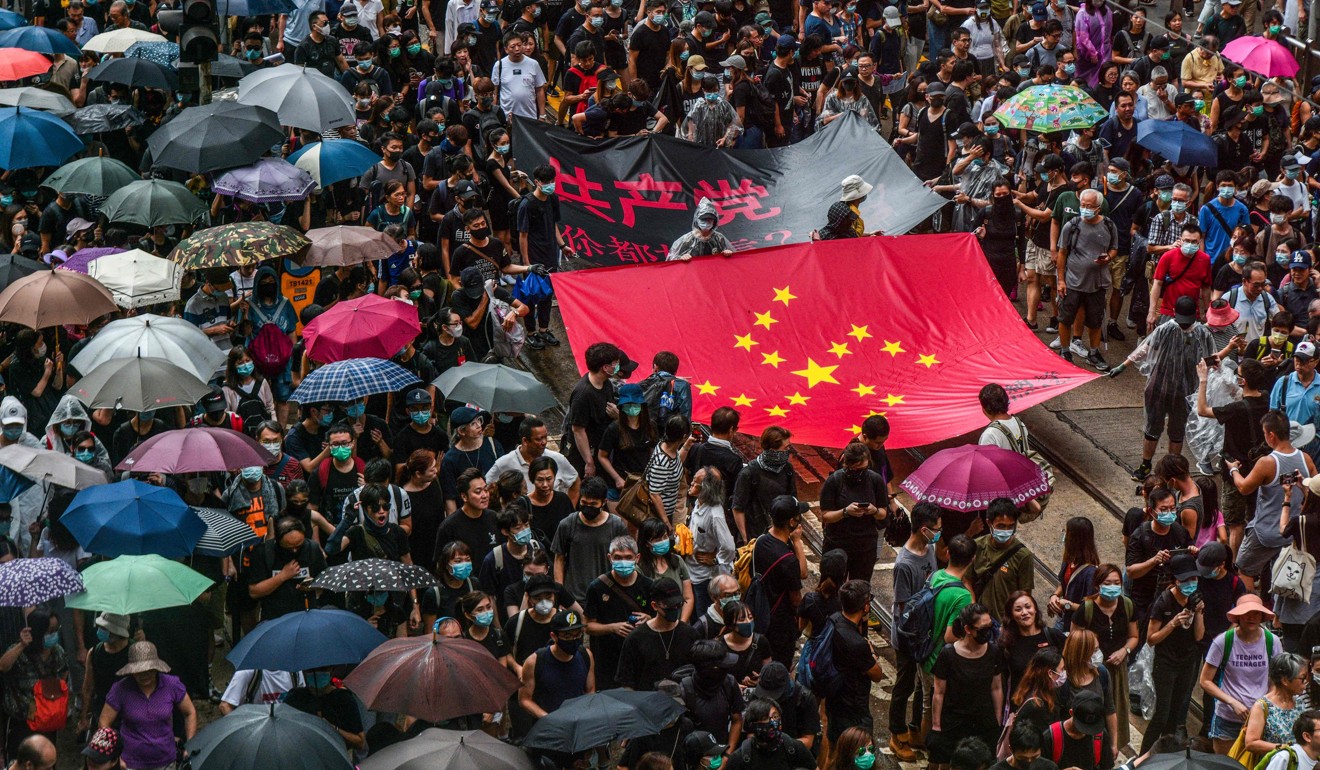 Protesters in Hong Kong with a banner that uses the stars of the Chinese national flag to depict a Nazi swastika. Photo: AFP