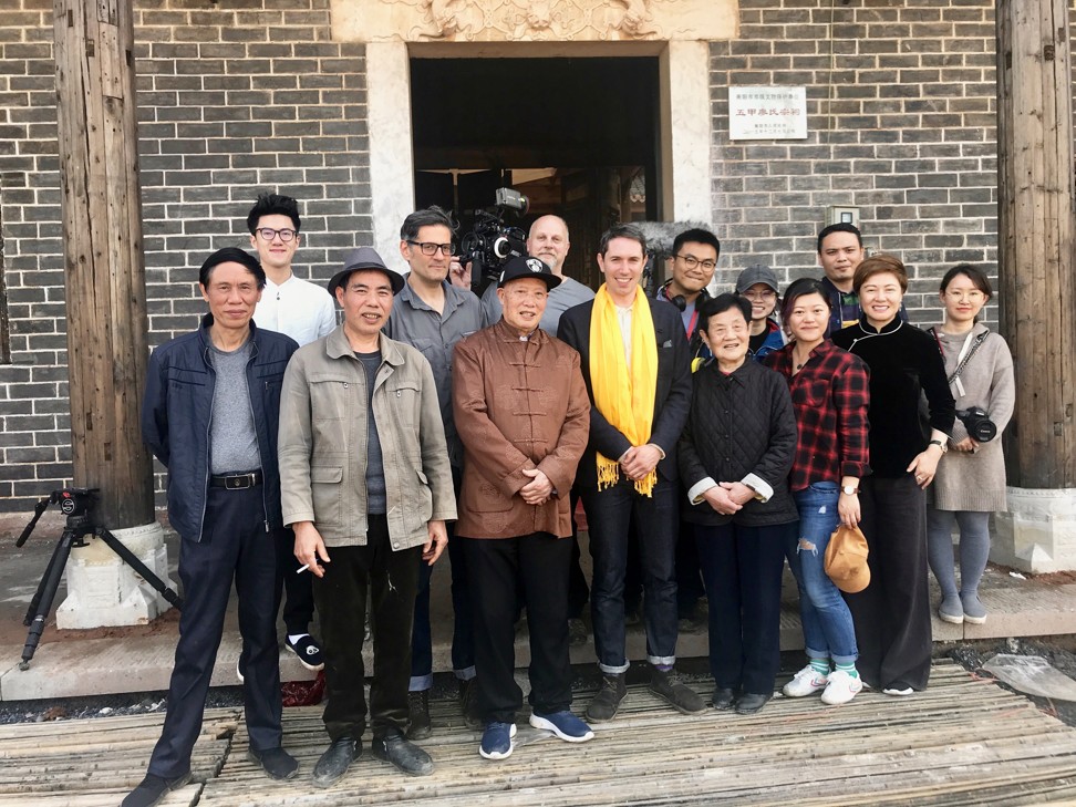 Alastair Sooke (wearing yellow scarf) with the film crew and local residents in Baogai, Hunan province, before going tomb sweeping. Photo: BBC