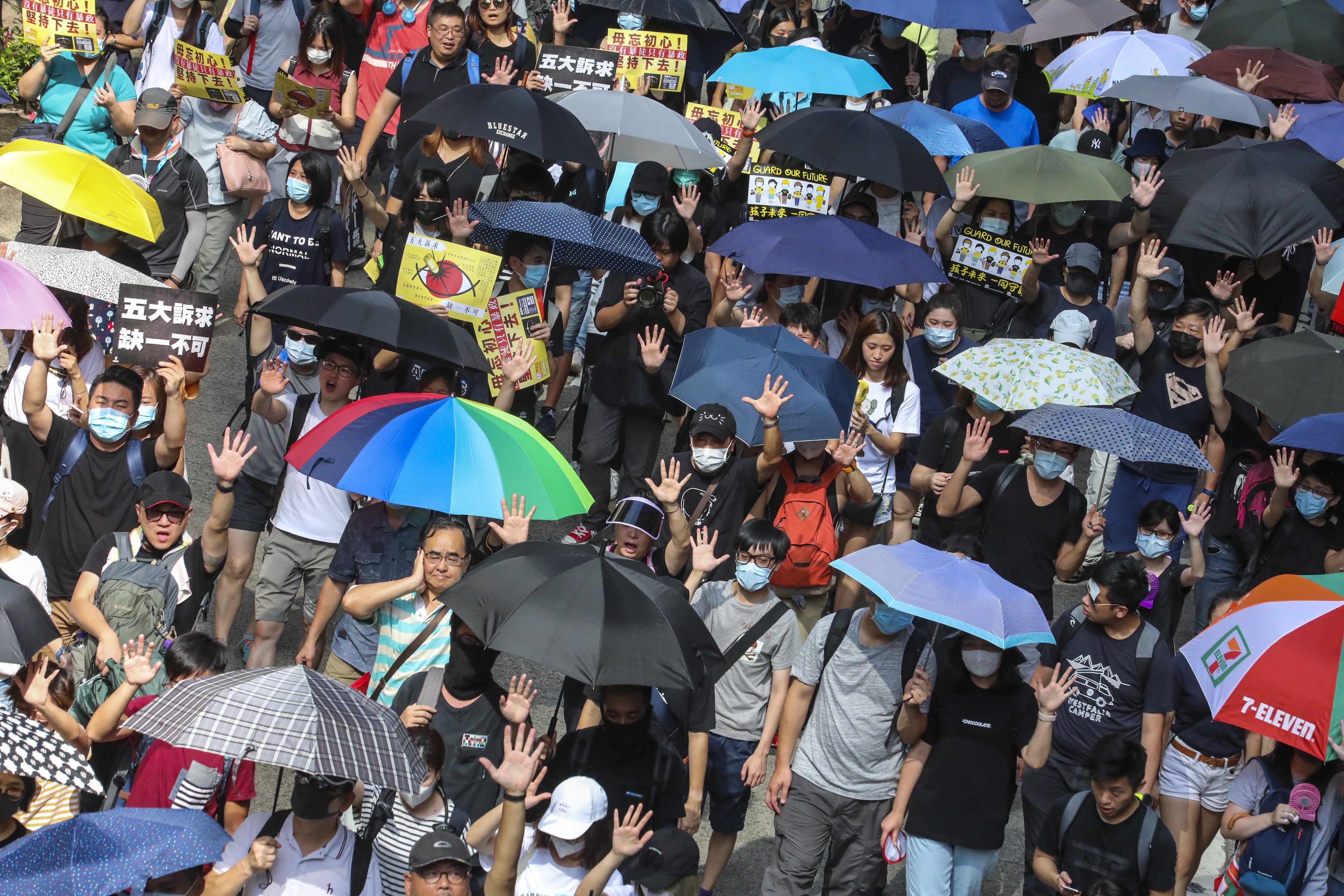 Protesters hold up the hands symbolising their five demands during a march in Hong Kong. Photo: Felix Wong