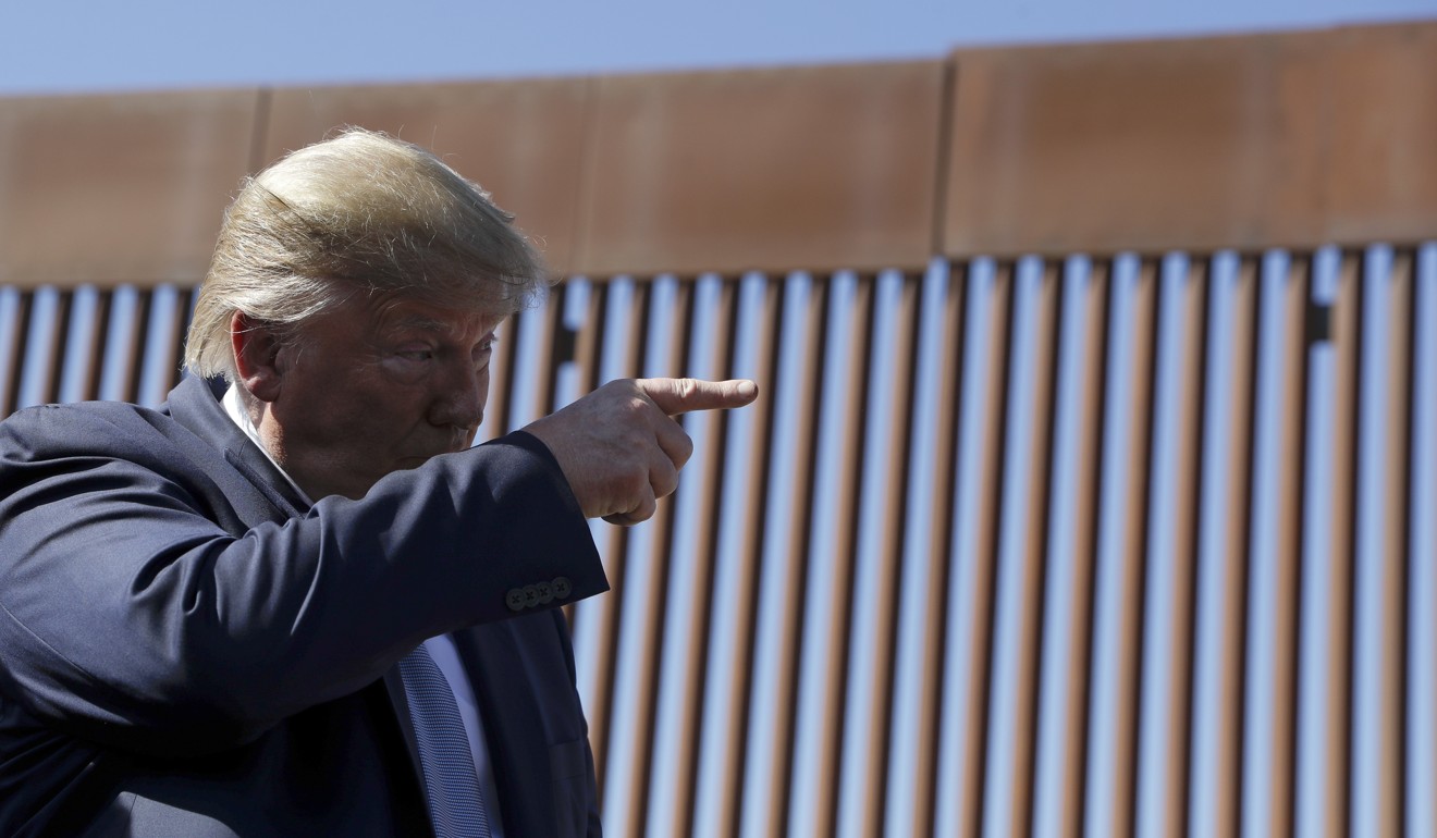 US President Donald Trump talks tours a section of the southern border wall. Photo: AP