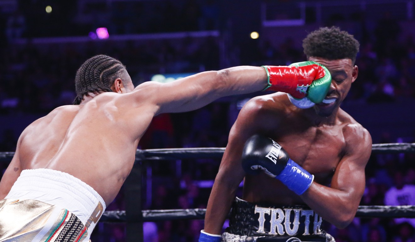 Shawn Porter lands a punch to the face of Errol Spence Jnr. Photo: AP