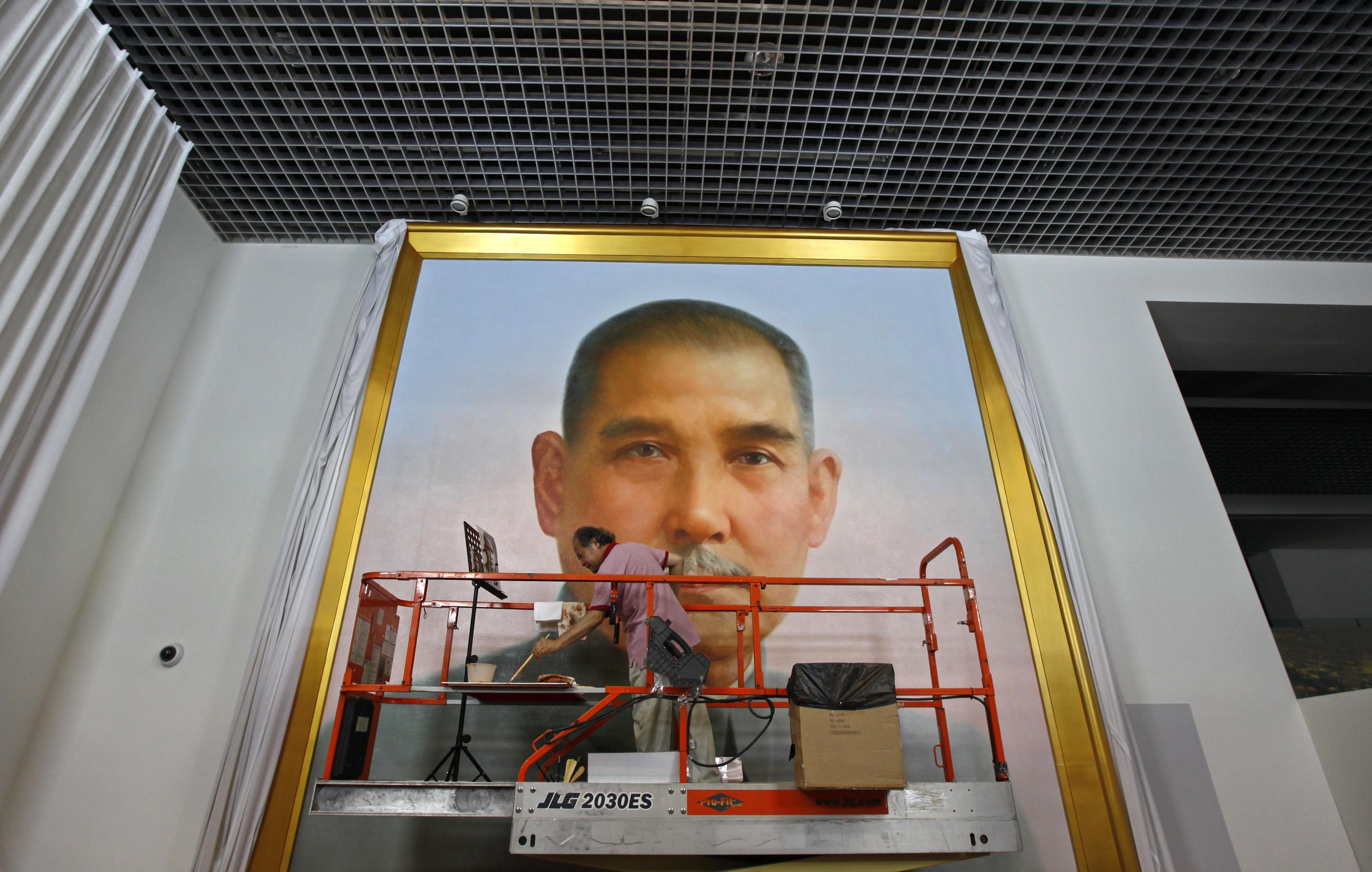 Ge Xiaoguang, a reclusive artist who painted the portrait of Mao Zedong that hangs over Tiananmen Square, works on a giant depiction of Sun Yat-sen, the father of modern China, at a studio in Beijing. Photo: Reuters