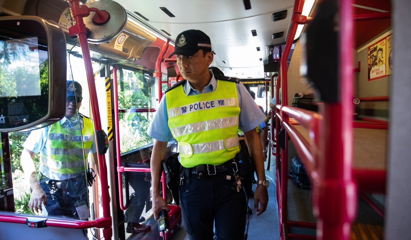 Police officers on a bus going to the airport this month. Photo: Bloomberg