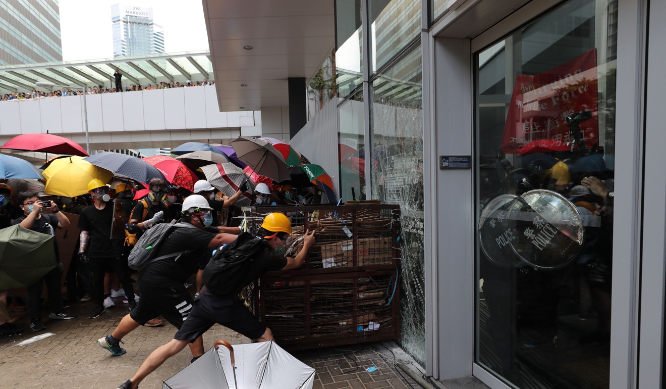 Protesters smash windows of the Legislative Council complex in Tamar during a protest against the extradition bill on July 1. Photo: Sam Tsang