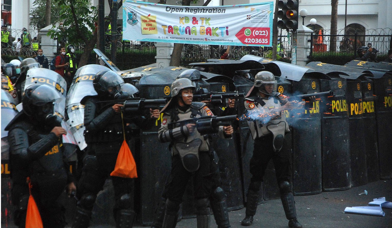Riot police fire tear gas towards protesters during a demonstration in Bandung. Photo: AFP