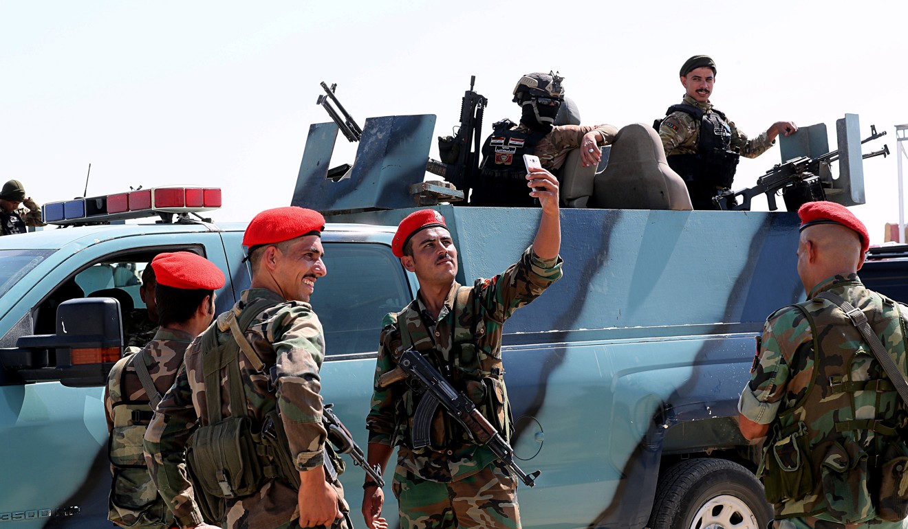 Syrian soldiers take a picture with an Iraqi patrol during the opening ceremony. Photo: AP