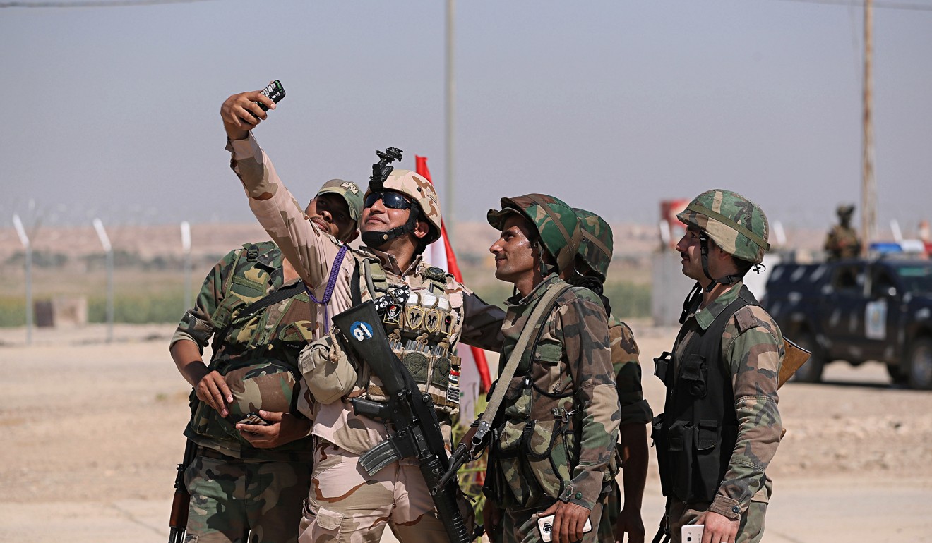 Iraqi and Syrian security forces take a picture during the opening ceremony. Photo: AP