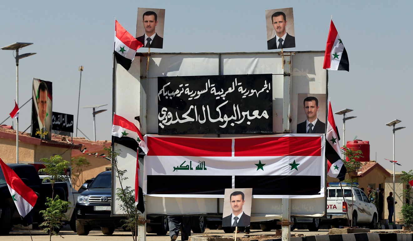 Posters of Syrian President Bashar al-Assad are seen at the Iraqi-Syrian border. Photo: Reuters
