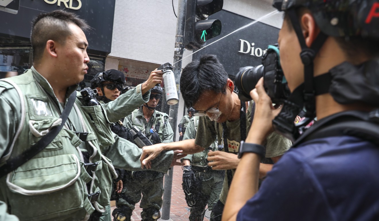 Riot police shoot pepper spray at protesters as they gather for an anti-extradition bill march fon Sunday. Photo: Nora Tam