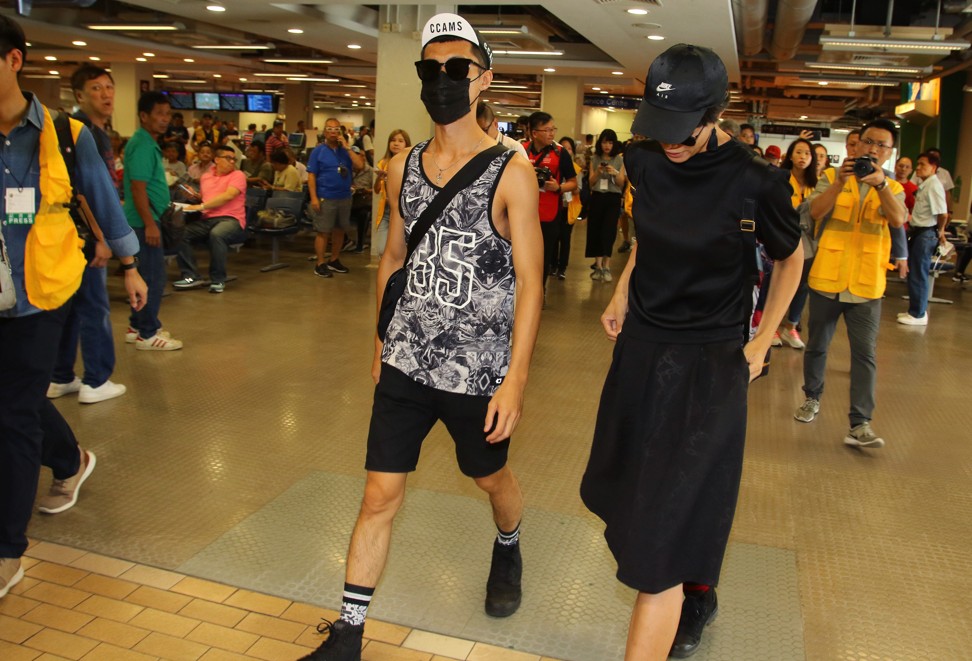 Two people who chanted after China’s national anthem leave Sha Tin. Photo: Handout