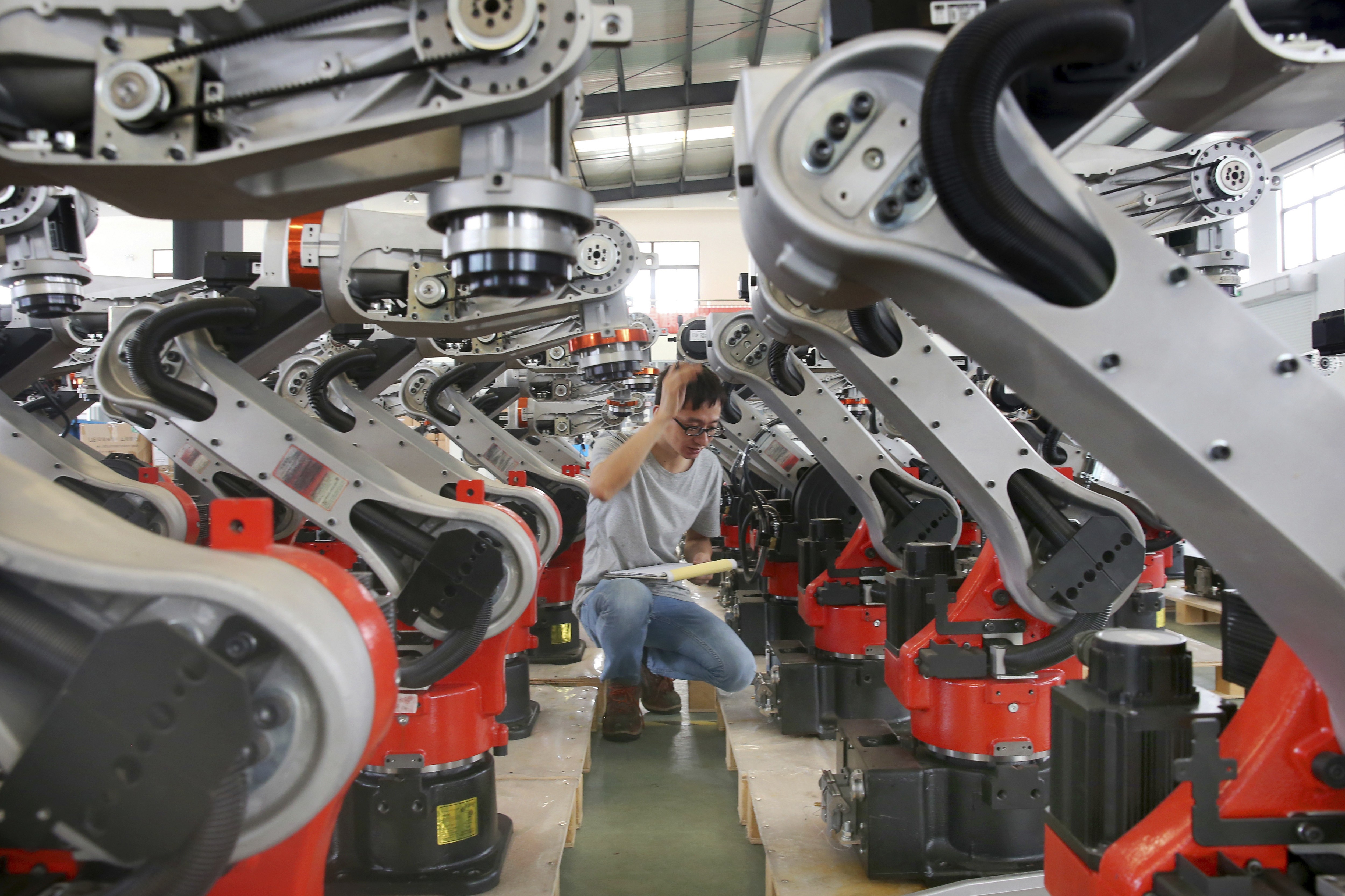 Checks are carried out on robotic arms at a factory producing industrial robots in Zhengyu town, in east China’s Jiangsu province. As China gets ready for a key Communist Party core committee meeting in October, policymakers are likely to increasingly prioritise manufacturing. Photo: AP