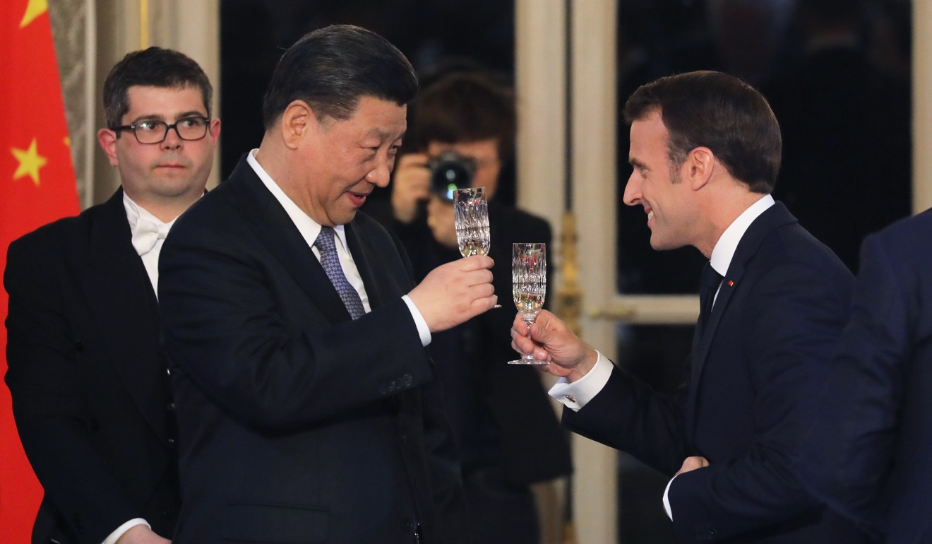 Chinese President Xi Jinping and French leader Emmanuel Macron toast raise a toast during a state dinner in Paris on March 25. Photo: EPA-EFE