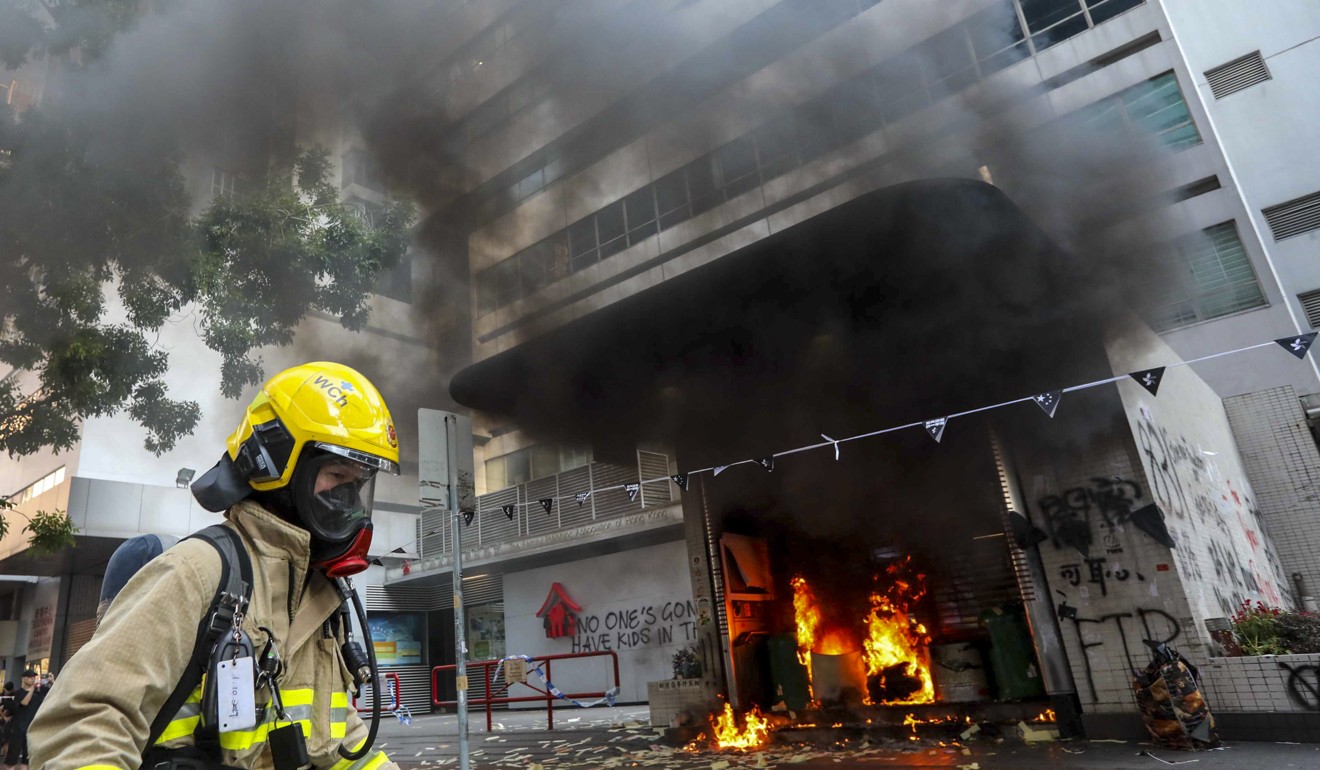 Firefighters respond to a fire at an exit of Wan Chai MTR Station. Photo: Felix Wong