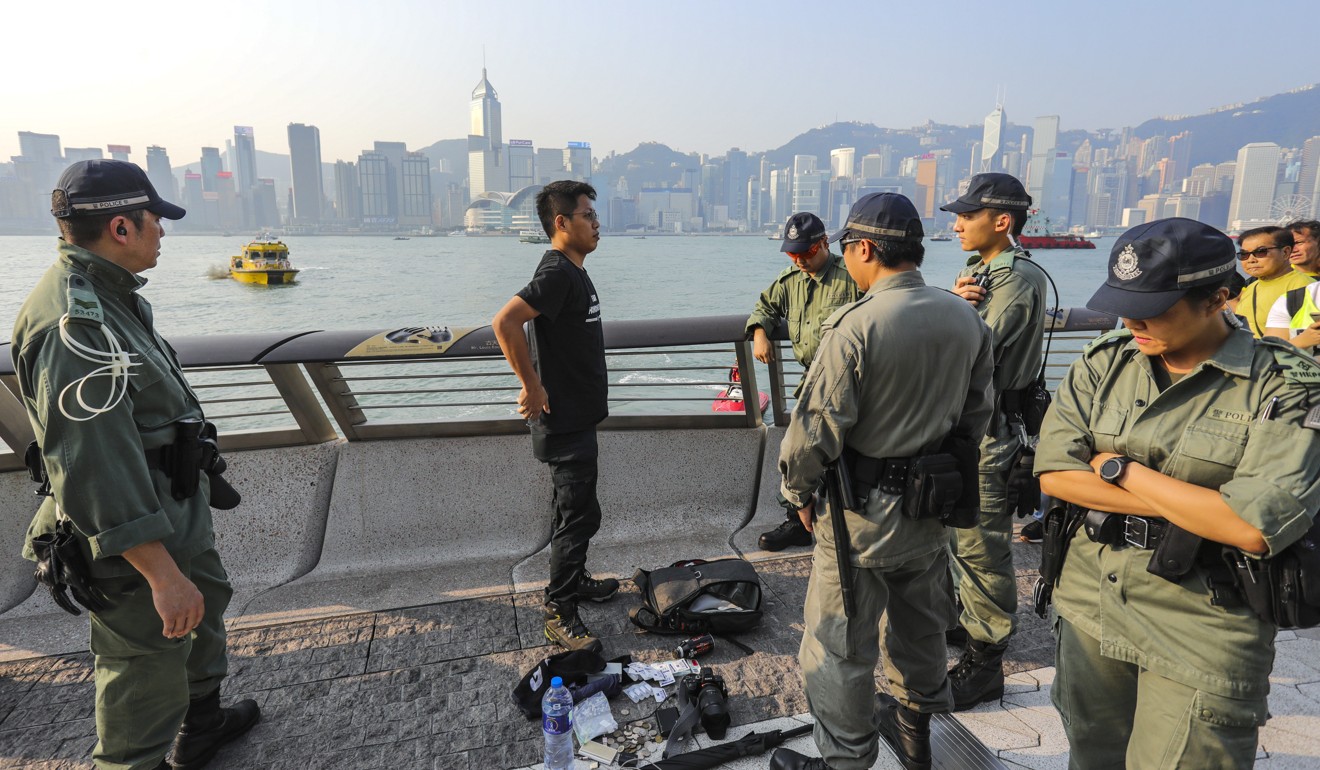 Hong Kong police officers search suspects along the harbourfront on October 1, amid celebrations marking the 70th anniversary of the People’s Republic of China. Photo: May Tse
