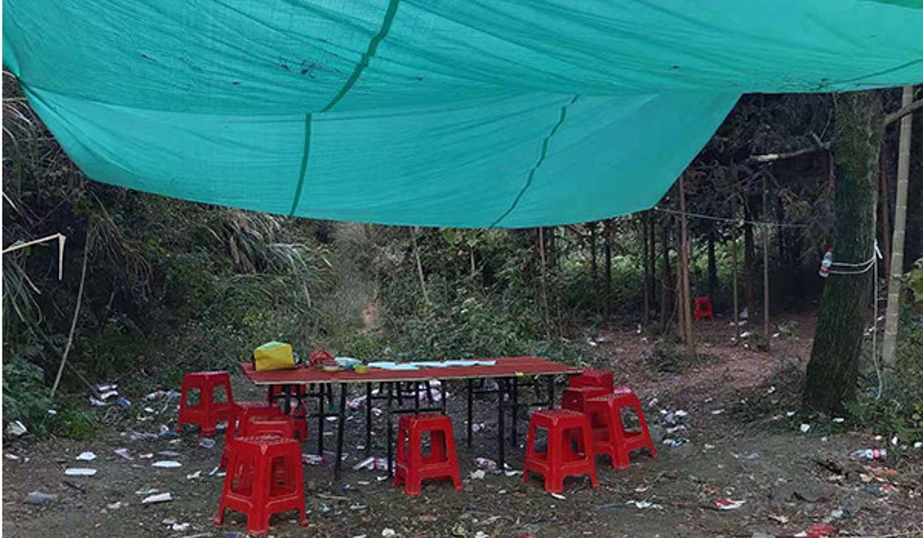 The den comprised tables and chairs under a tarpaulin slung from branches. Photo: Handout