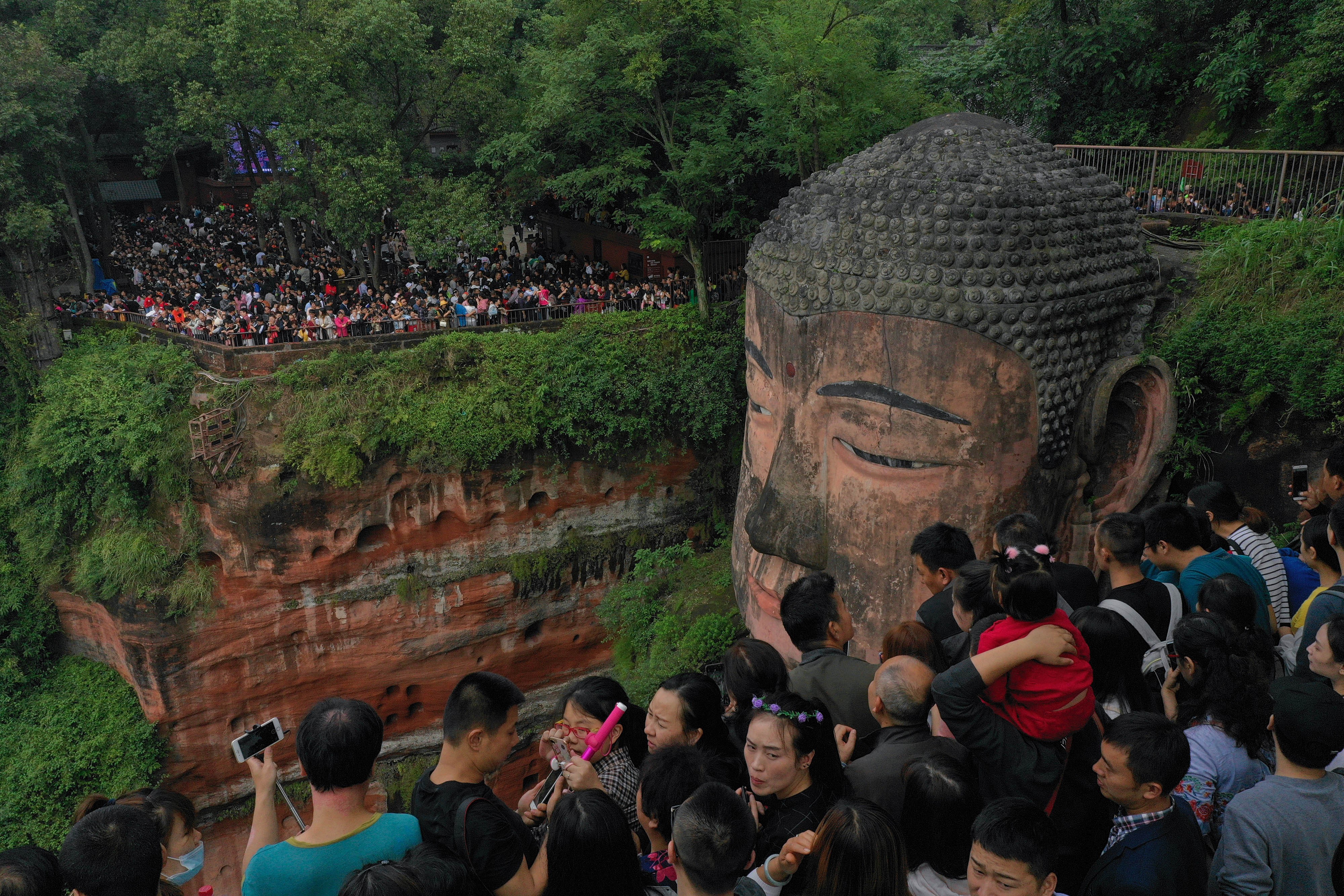 Park authorities in charge of the Leshan Giant Buddha in Sichuan have restricted visitor numbers in golden week. Photo: Xinhua