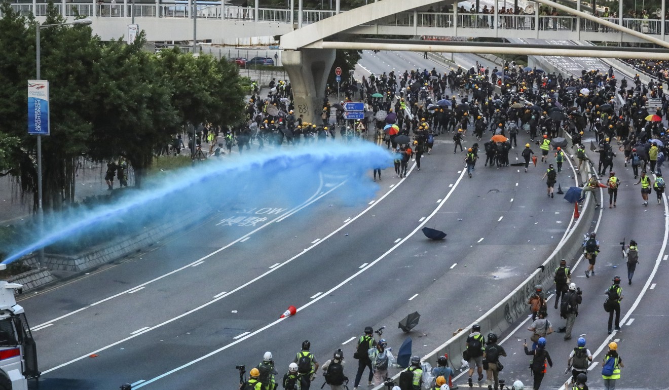 Blue dye fired from police water cannons. Photo: K. Y. Cheng