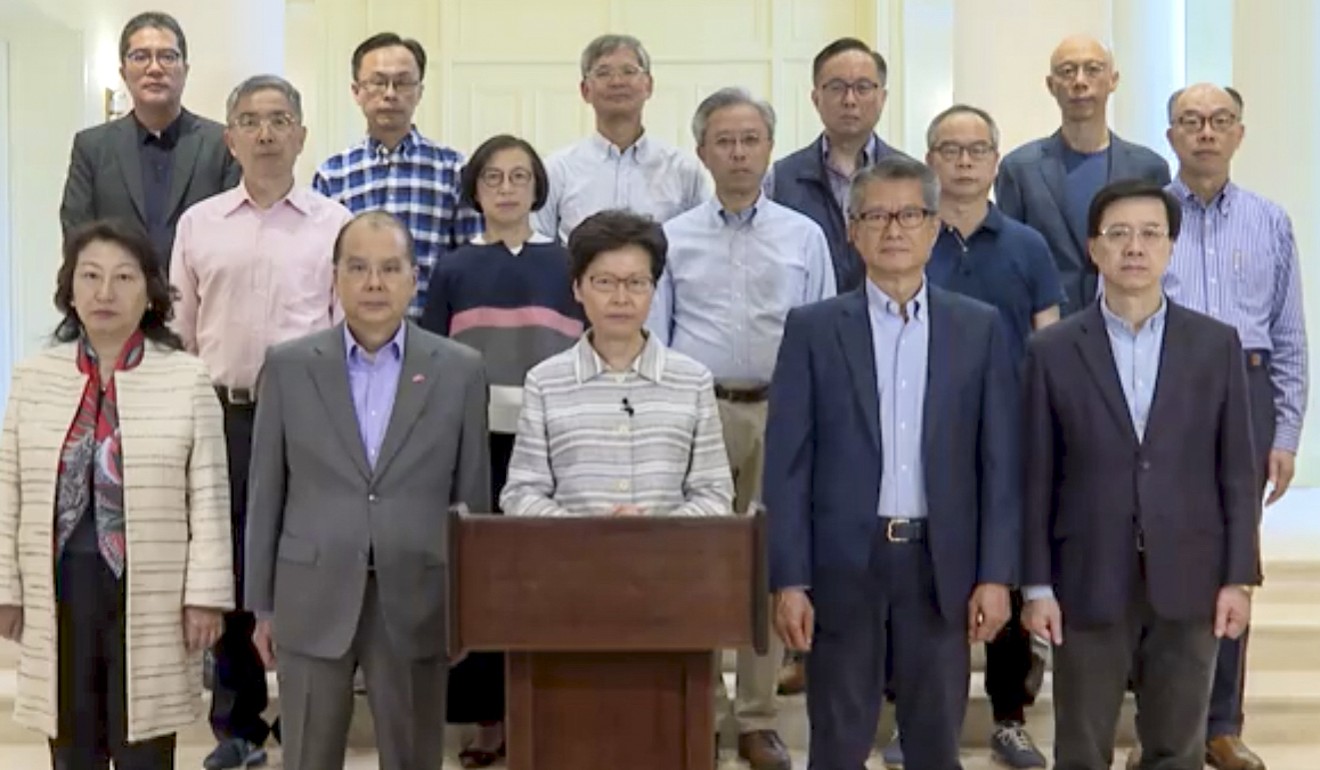 Chief Executive Carrie Lam, flanked by 14 of her ministers, blasted the acts of rioters on Friday night and called them ‘shocking and outrageous’. Photo: Handout