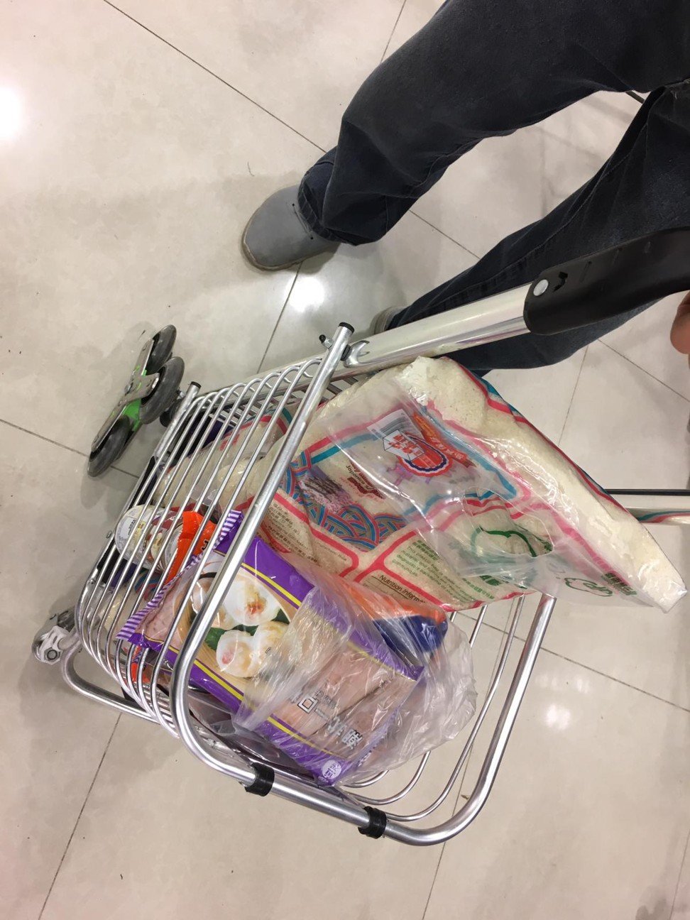One local resident bought three bags of rice totalling 15kg and a trolley of frozen dim sum at a ParknShop supermarket in Tsuen Wan. Photo: Fiona Sun