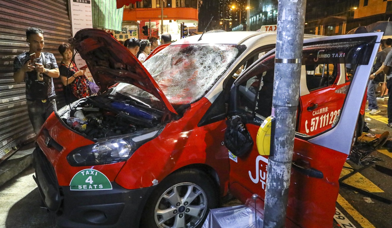 A taxi was smashed after an incident in Sham Shui Po and the driver was beaten up. Photo: K.Y. Cheng