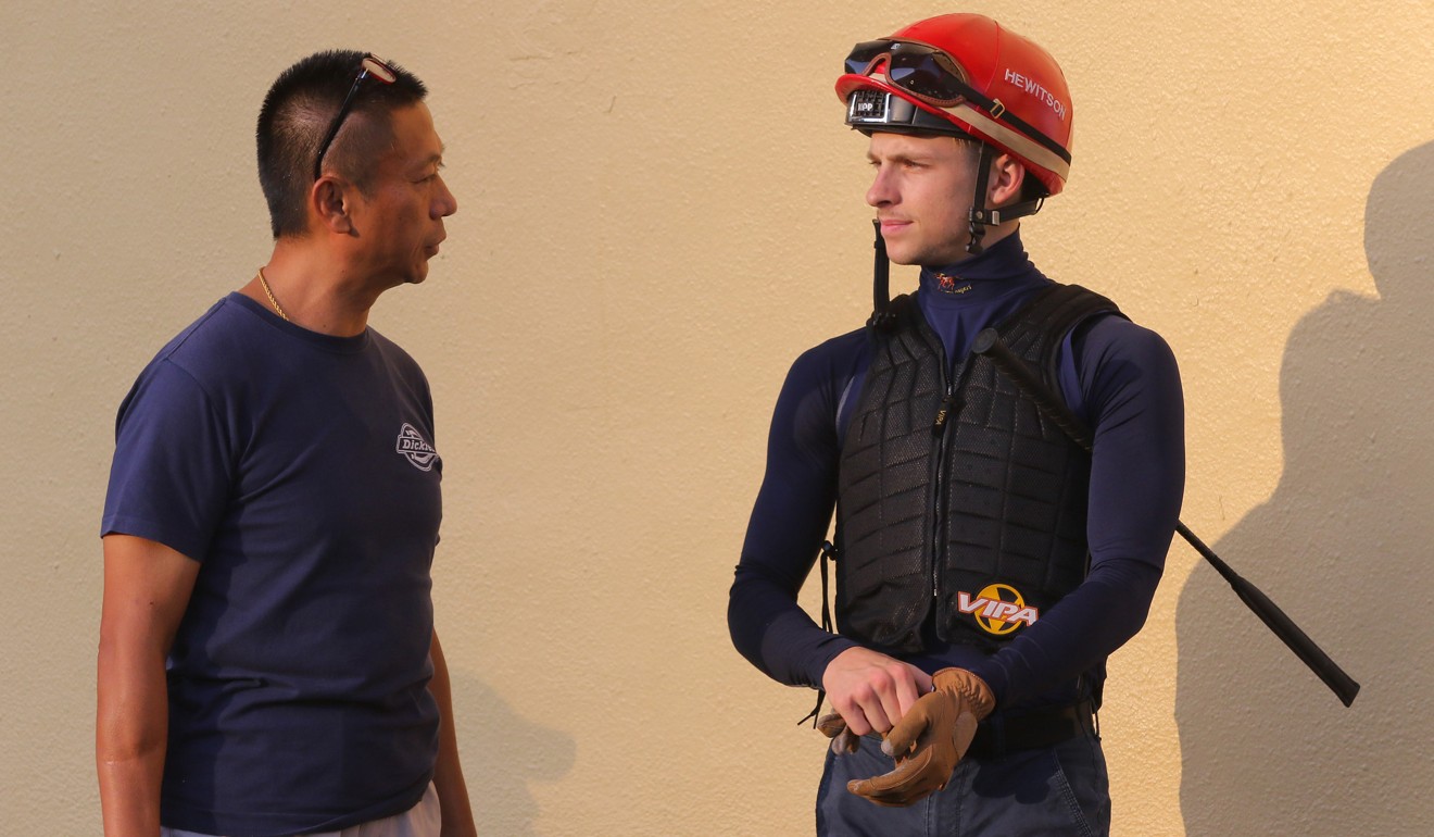 Trainer Danny Shum talks to jockey Lyle Hewitson.