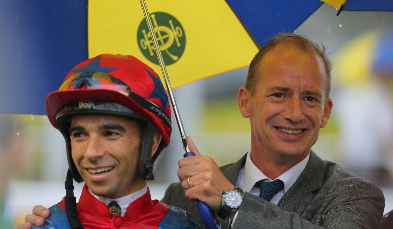 Richard Gibson celebrates a winner with jockey Joao Moreira.