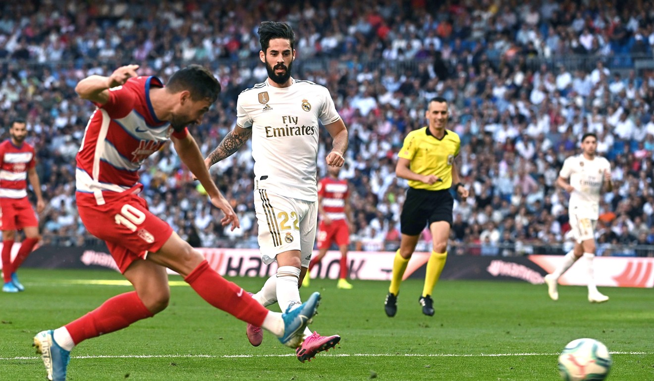 Real Madrid’s Isco (centre) in action against Granada's Antonio Puertas (left) at the Santiago Bernabeu in Madrid. Photo: EPA