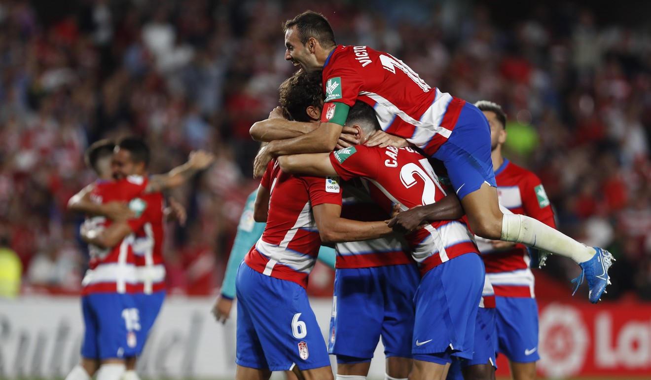 Granada's players celebrate after beating Barcelona. Photo: AP
