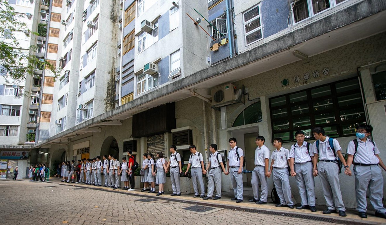 About 150 students and 10 alumni of Christ College in Shatin formed a human chain outside Pok Hong Estate. Photo: Kelly Ho